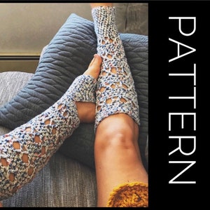 May include: Speckled yarn crocheted leg warmers with an openwork design. The leg warmers are white with blue, red, and yellow flecks. The word "PATTERN" is written vertically in white on a black background.
