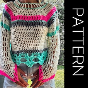 May include: A white crochet top with a colorful striped pattern in pink, teal, and gray. The top has a loose fit and long sleeves with a crocheted lace trim.