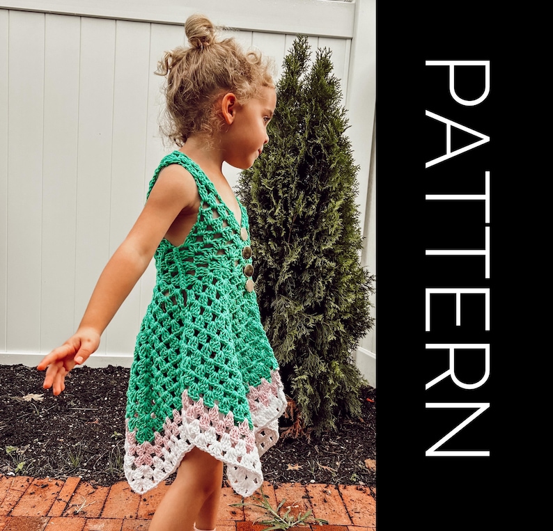 May include: A green crochet dress with a V-neck and button closure. The dress features a white and pink patterned hemline. The word "PATTERN" is printed vertically in white on a black background.