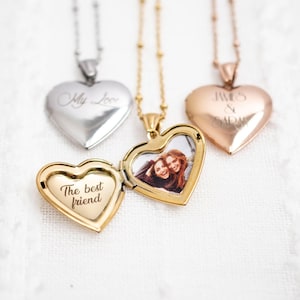 May include: Heart-shaped locket necklaces in silver, gold, and rose gold. One gold locket is open, revealing a photo and the inscription "The best friend." Other lockets have the inscriptions "My Love" and "James & Sarah."