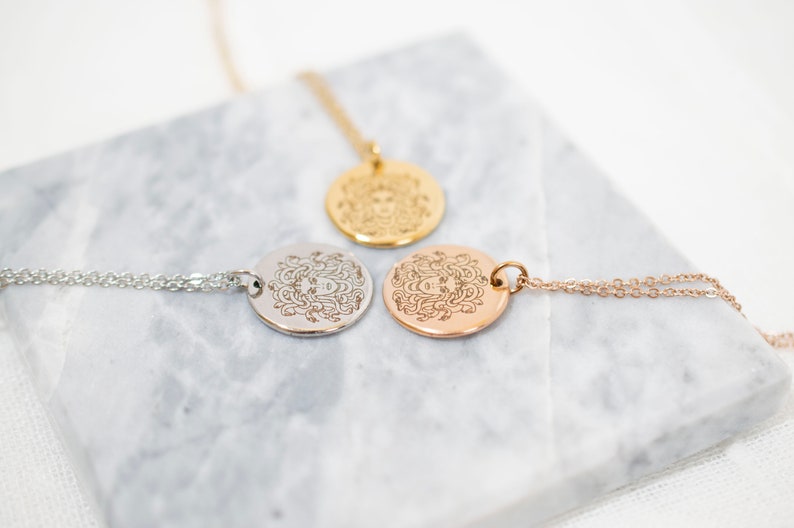 Silver gold and rose gold Medusa necklaces side by side