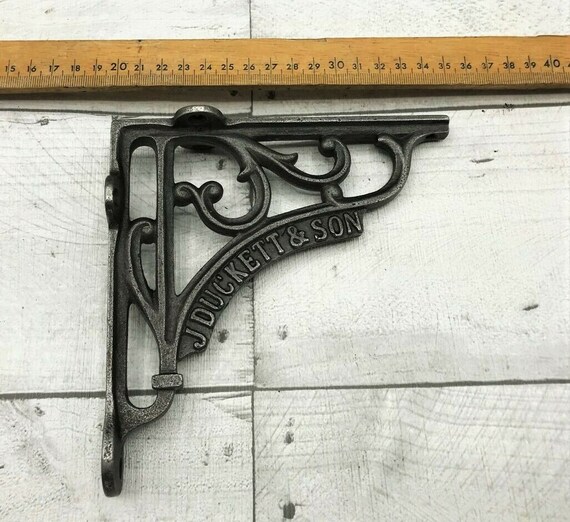 Two pair of cast iron antique style J Duckett & Son brackets shelf