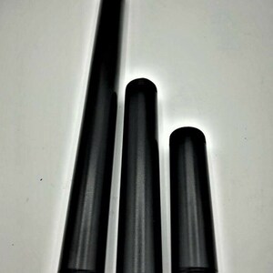 May include: Three black metal pipes of different lengths. The pipes are threaded on both ends.