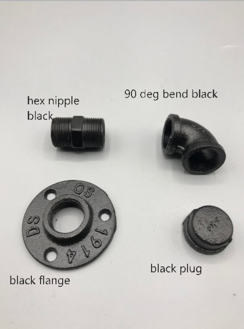 May include: A set of black iron pipe fittings, including a hex nipple, 90 degree bend, flange, and plug. The flange is marked with the numbers 1/2 and 1971.