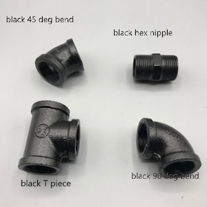 May include: Four black metal pipe fittings: a 45-degree elbow, a 90-degree elbow, a T-shaped connector, and a straight hex nipple.