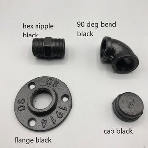 May include: Black metal pipe fittings, including a hex nipple, 90 degree bend, flange, and cap.