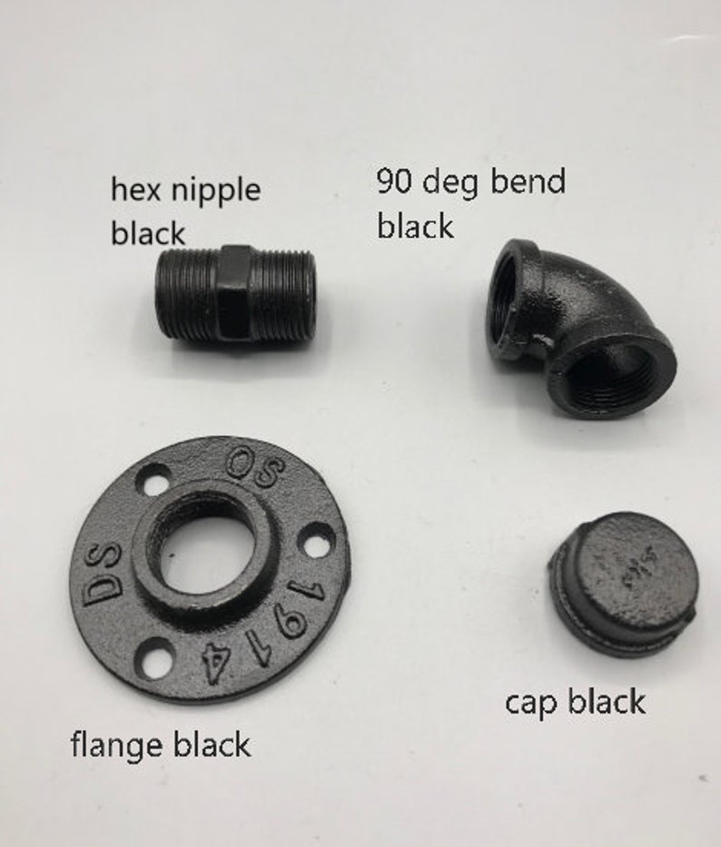 May include: Black metal pipe fittings, including a hex nipple, 90 degree bend, flange, and cap.