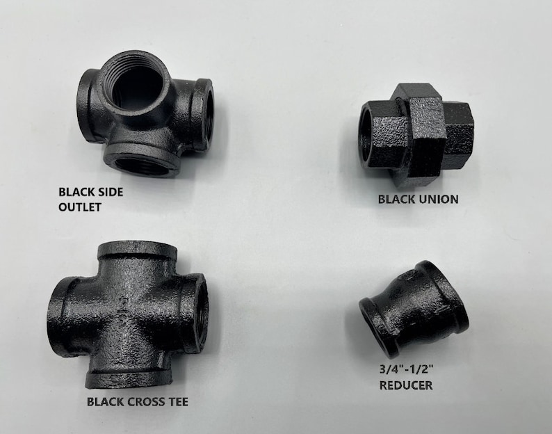 May include: Four black iron pipe fittings: a side outlet, a union, a cross tee, and a 3/4-inch to 1/2-inch reducer.
