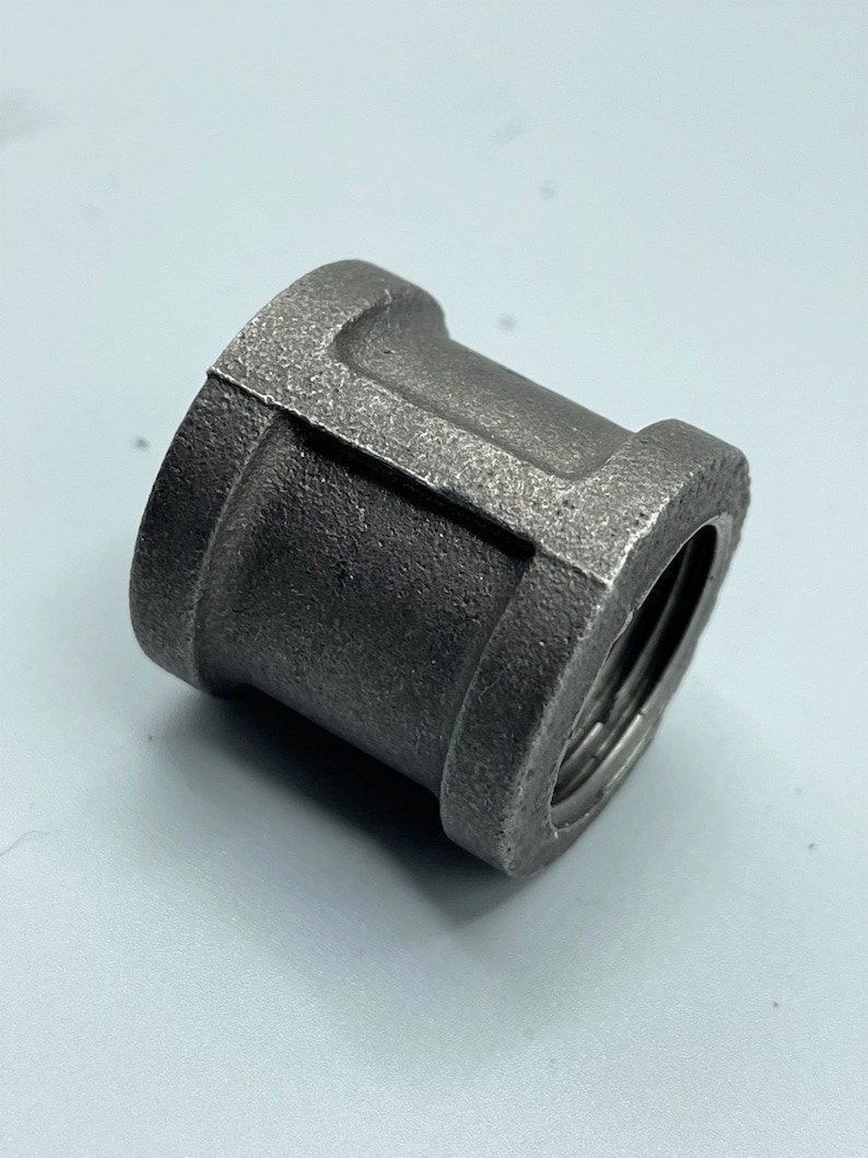 May include: A black metal pipe fitting with threaded ends.