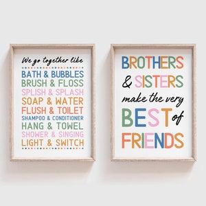 May include: Two framed prints with colorful text. The first print says "We go together like" and lists pairs of words like "Bath & Bubbles" and "Light & Switch". The second print says "Brothers & Sisters make the very best of friends".