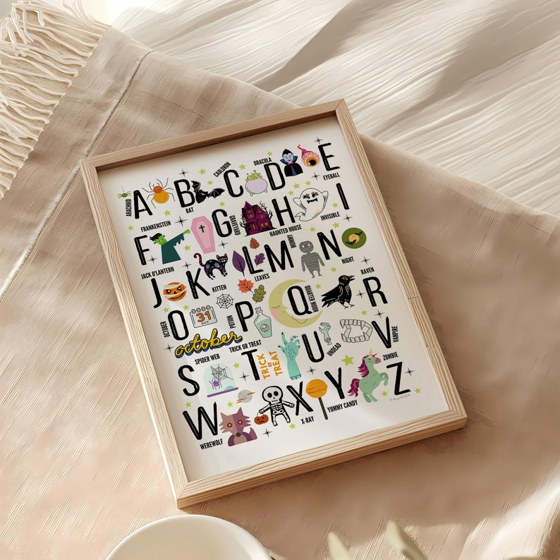 May include: A white poster with a black frame features a Halloween alphabet with illustrations for each letter. The letters are in a colorful font with black outlines. The illustrations include a bat, a ghost, a haunted house, a spider web, a pumpkin, a raven, a werewolf, a skeleton, a candy corn, and a unicorn. The poster also includes the word "october" with a calendar icon and the numbers 31.