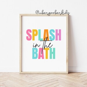 May include: A colorful print with the text "SPLASH in the BATH" in a rainbow of colors. The text is in a bold, playful font.