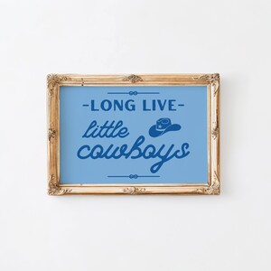 May include: A framed print with a blue background and white text that reads "Long Live Little Cowboys" with a silhouette of a cowboy hat above the text.