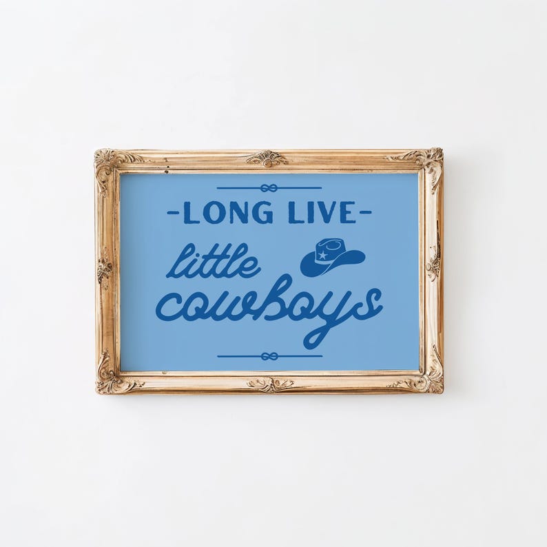 May include: A framed print with a blue background and white text that reads "Long Live Little Cowboys" with a silhouette of a cowboy hat above the text.