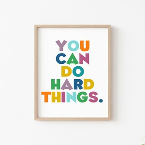 May include: A framed print with the text "YOU CAN DO HARD THINGS." in colorful letters on a white background.