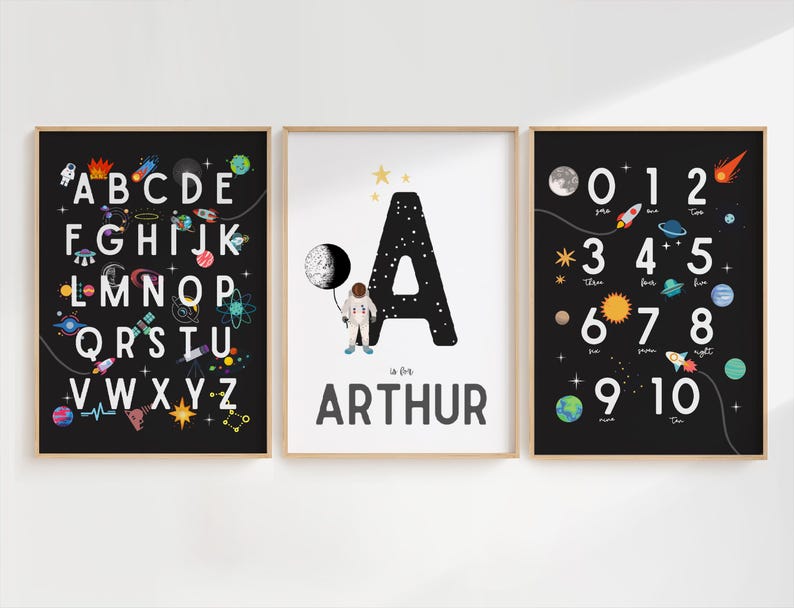 May include: Three black framed prints with a space theme. The first print features the alphabet with space-themed illustrations. The second print features the letter A with a spaceman and the name Arthur. The third print features numbers 1-10 with space-themed illustrations.