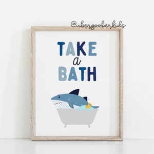 May include: A blue and white illustrated print with the text "TAKE a BATH" and a cartoon shark in a bathtub with a rubber ducky.