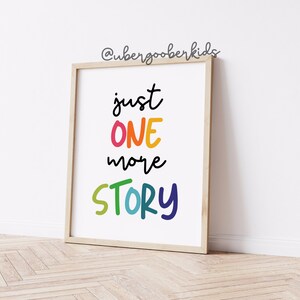 May include: A framed print with the text "just one more story" in colorful, handwritten letters. The background is white.