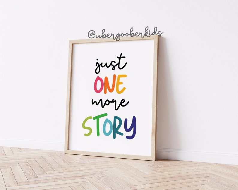 May include: A framed print with the text "just one more story" in colorful, handwritten letters. The background is white.