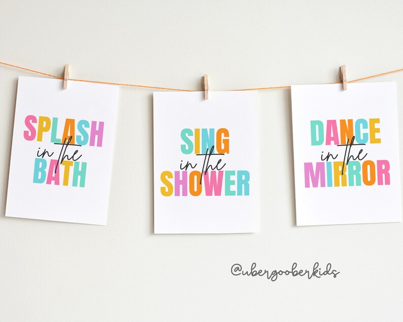 May include: Three colorful printable wall art prints with the text "Splash in the Bath", "Sing in the Shower", and "Dance in the Mirror".