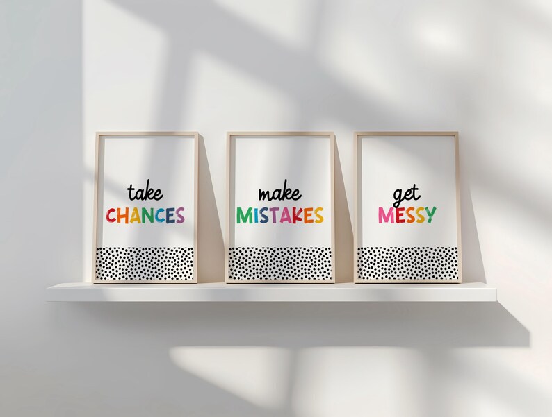 May include: Three framed prints with a white background and black polka dots. The text on the prints reads "take chances", "make mistakes", and "get messy". The text is in rainbow colors.