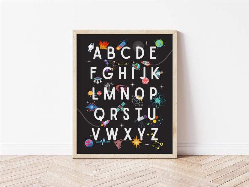 May include: A black and white alphabet poster with a space theme. The letters are white and surrounded by colorful planets, stars, rockets, and other space-related imagery.