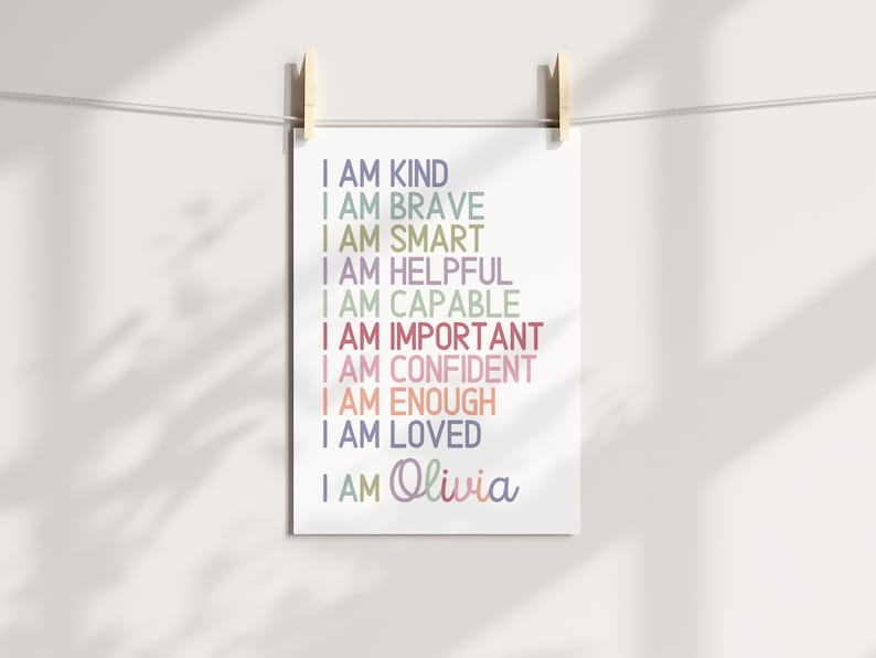May include: A printable wall art design with the text "I am kind, I am brave, I am smart, I am helpful, I am capable, I am important, I am confident, I am enough, I am loved, I am Olivia" in various colors.