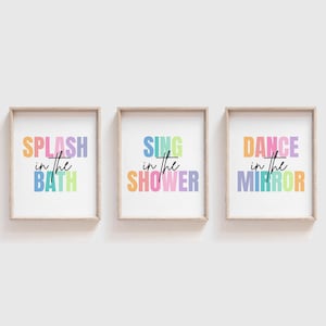 May include: Three framed prints with colorful text. The first print says "Splash in the Bath", the second print says "Sing in the Shower", and the third print says "Dance in the Mirror".
