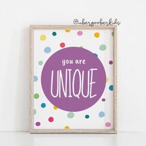 May include: A framed print with a purple circle on a white background with colourful polka dots. The circle says "you are UNIQUE" in white text.