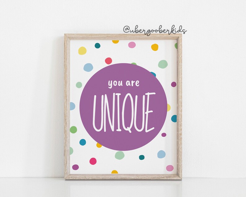 May include: A framed print with a purple circle on a white background with colourful polka dots. The circle says "you are UNIQUE" in white text.