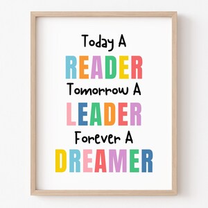 May include: A framed print with the text "Today a Reader, Tomorrow a Leader, Forever a Dreamer" in colorful letters. The background is white.