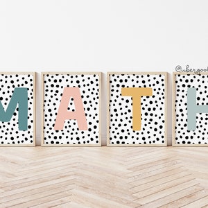 May include: Four framed prints spelling out the word "MATH" in colorful letters on a black and white polka dot background.