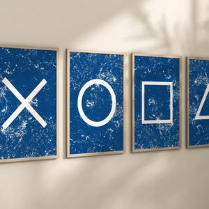 May include: Four framed prints with a distressed blue background and white geometric shapes. The shapes are a circle, a square, a triangle, and an X.
