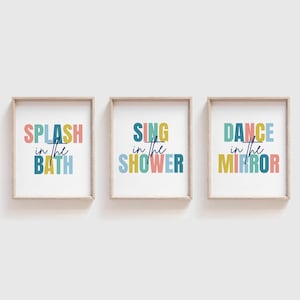 May include: Three framed prints with colourful text. The first print says "Splash in the Bath", the second print says "Sing in the Shower", and the third print says "Dance in the Mirror".
