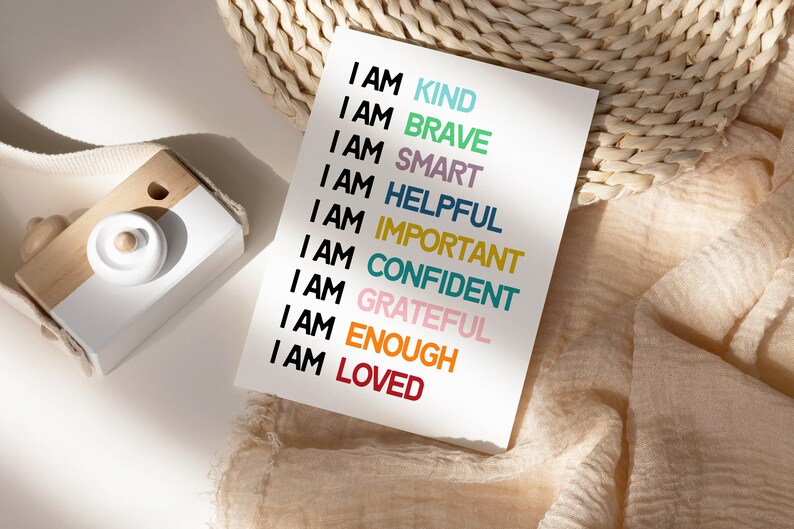 May include: A white card with the text "I AM" followed by a list of positive affirmations in different colors: kind, brave, smart, helpful, important, confident, grateful, enough, and loved.