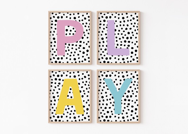 May include: Four framed prints with a black and white polka dot background and a single letter in a bright colour on each print. The letters spell out the word "PLAY" with pink "P", purple "L", yellow "A", and blue "Y".