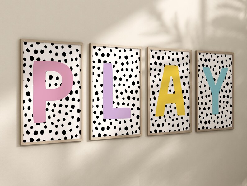 May include: Four framed prints with a black and white polka dot background and large colourful letters spelling out the word "PLAY". The letters are pink, purple, yellow, and blue.
