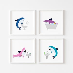 May include: Set of four framed prints featuring cartoon sharks in various bathroom settings. The prints feature a blue shark brushing its teeth, a purple shark taking a bath, a pink shark brushing its teeth, and a blue shark washing its face.