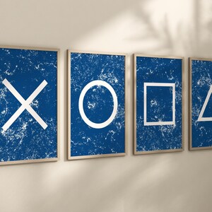 May include: Four framed prints with a distressed blue background and white geometric shapes. The shapes are a circle, a square, a triangle, and an X.
