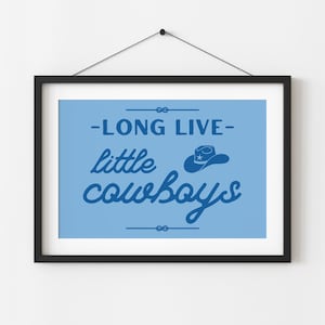May include: A blue and white framed print with the text "Long Live Little Cowboys" and a silhouette of a cowboy hat with a star on it.