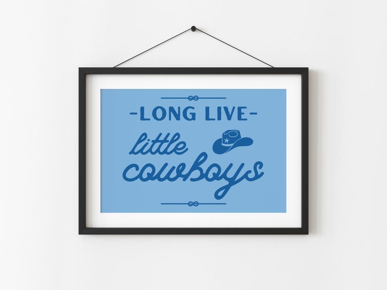 May include: A blue and white framed print with the text "Long Live Little Cowboys" and a silhouette of a cowboy hat with a star on it.
