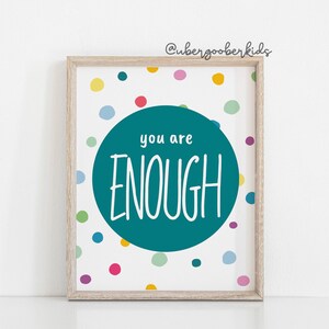 May include: A teal blue circle with the text "you are ENOUGH" in white on a white background with colourful polka dots.