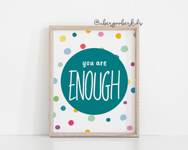 May include: A teal blue circle with the text "you are ENOUGH" in white on a white background with colourful polka dots.