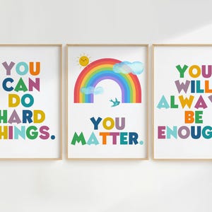 May include: Three colorful framed prints with rainbow designs and motivational text. The first print says "You can do hard things." The second print features a rainbow with a sun and a bird and says "You matter." The third print says "You will always be enough."