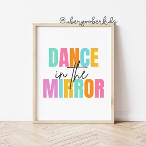 May include: A colorful printable wall art print with the text "DANCE in the MIRROR" in a rainbow of colors. The text is in a bold, blocky font.