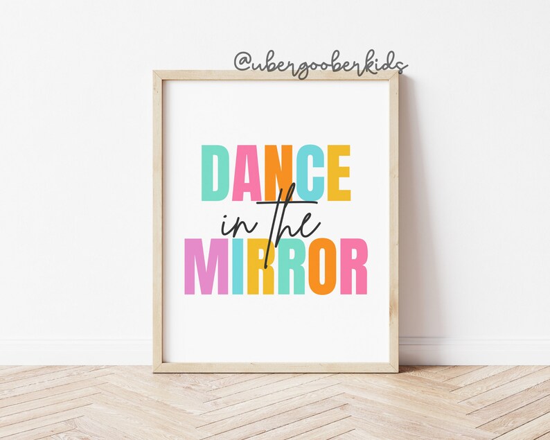 May include: A colorful printable wall art print with the text "DANCE in the MIRROR" in a rainbow of colors. The text is in a bold, blocky font.