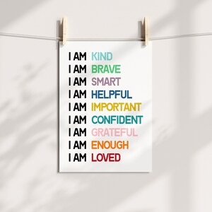 May include: A white printable poster with the text "I AM" followed by a list of positive affirmations in different colors: kind, brave, smart, helpful, important, confident, grateful, enough, and loved.