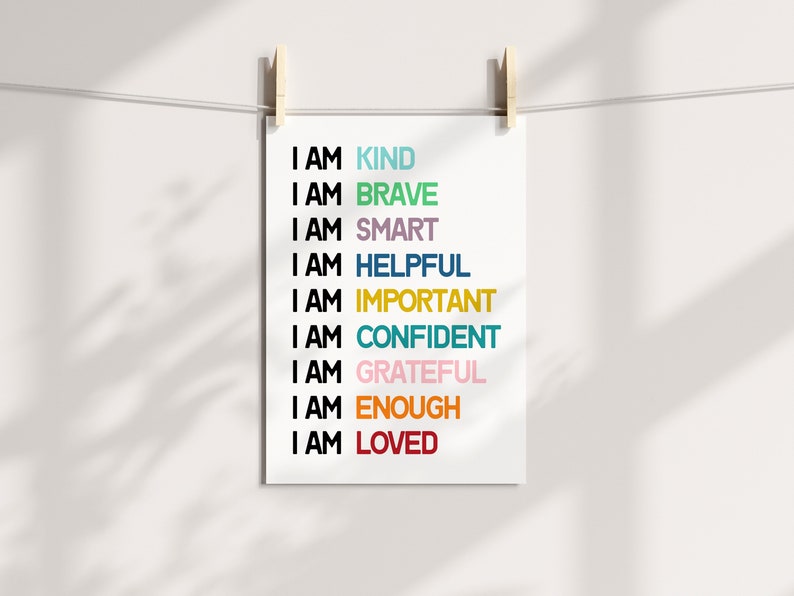 May include: A white printable poster with the text "I AM" followed by a list of positive affirmations in different colors: kind, brave, smart, helpful, important, confident, grateful, enough, and loved.