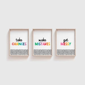 May include: Three framed prints with a black and white polka dot background. The text on the prints reads "take chances", "make mistakes", and "get messy". The text is in a rainbow of colors.