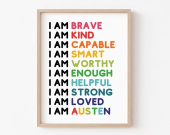 May include: A framed print with a white background and black text that reads "I am brave, I am kind, I am capable, I am smart, I am worthy, I am enough, I am helpful, I am strong, I am loved, I am Austen". The text is in a rainbow color scheme.